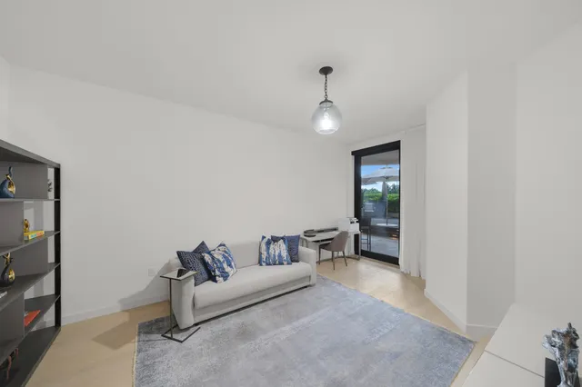 front view of a building with a garden and plants