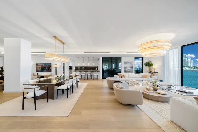 a living room with furniture a large window and a table