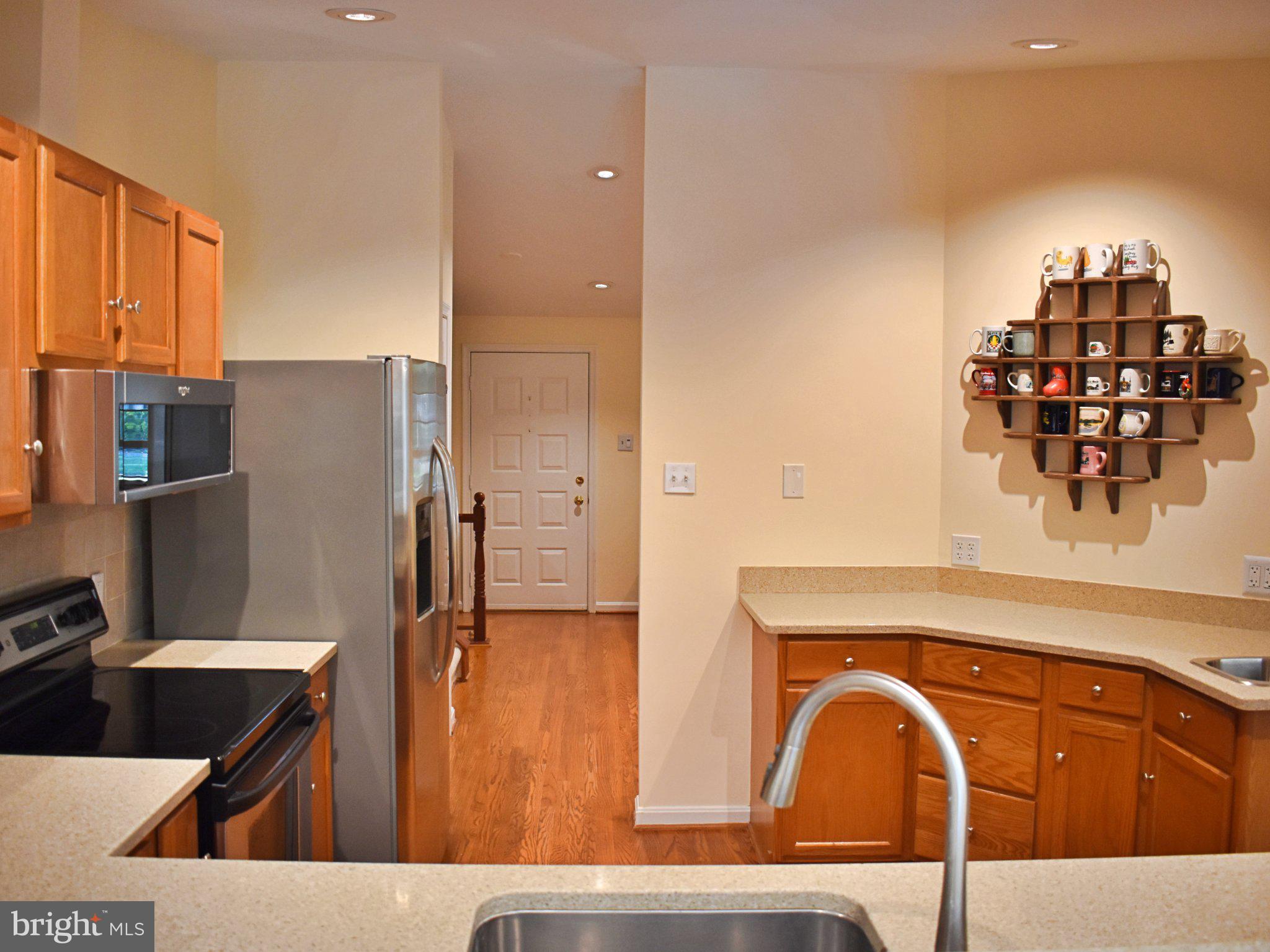 8097 Winding Way Court Springfield, VA 22153 - Photo 14 of 44 Modern kitchen with warm wood accents.