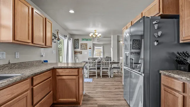 a kitchen with stainless steel appliances granite countertop a refrigerator and a sink