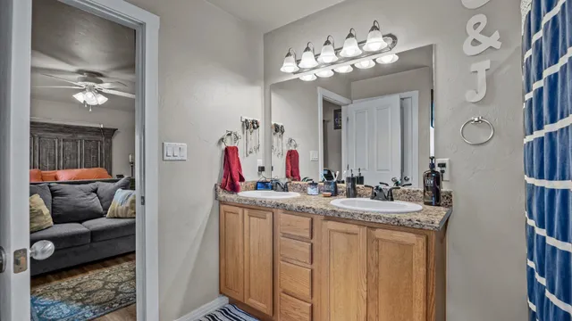 a en suite bathroom with a double vanity sink and a mirror