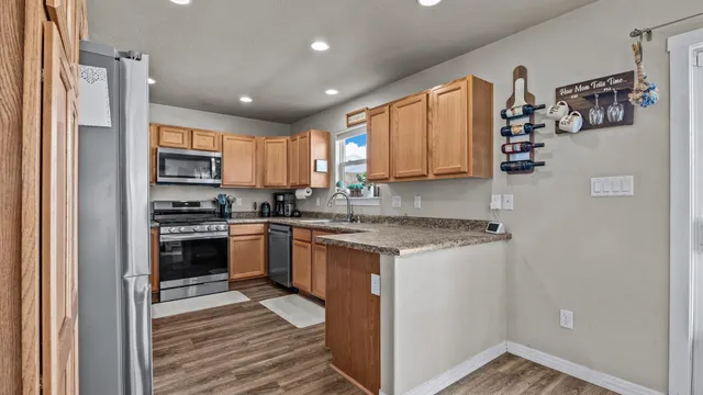 a kitchen with granite countertop stainless steel appliances and wooden cabinets