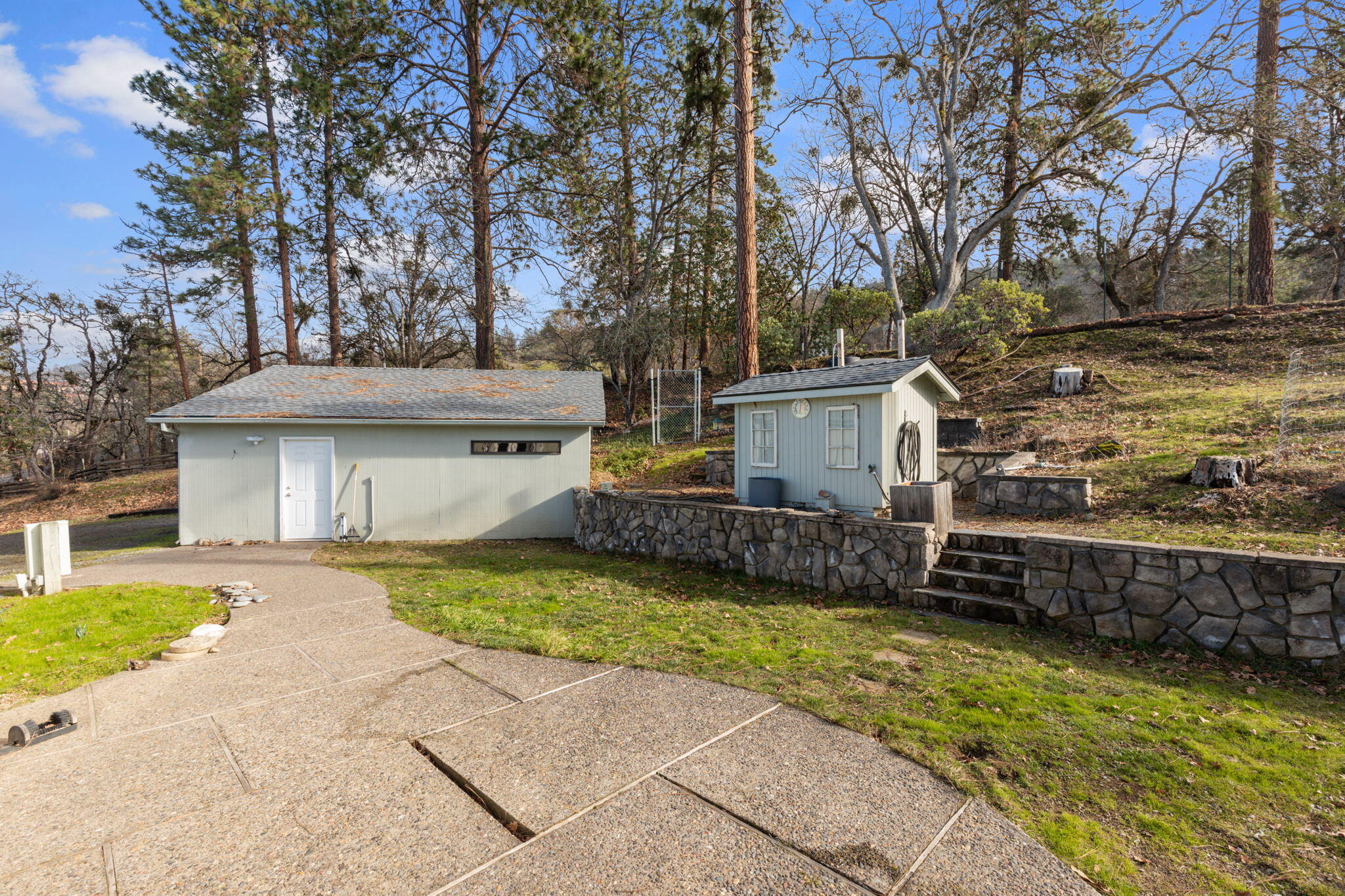 3746 Devils Garden Road Medford, OR 97504 - Photo 22 of 33 Back patio, garage, pump house & beautiful retaining wall.