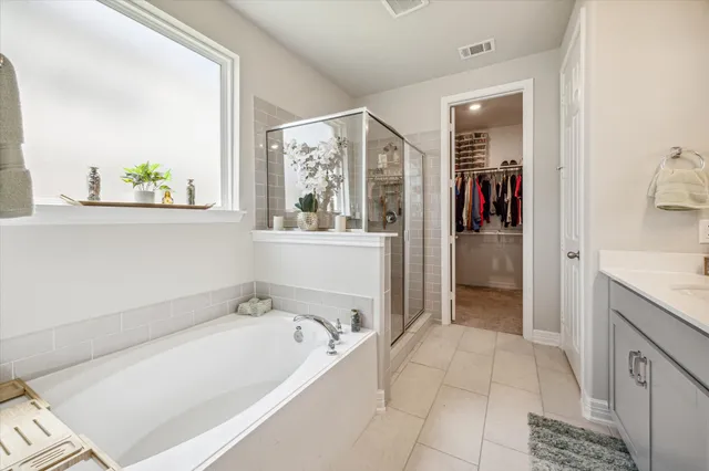 a spacious bathroom with a tub and shower