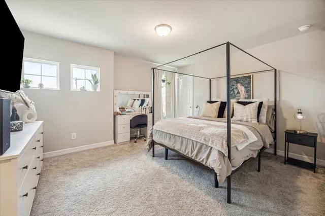 a bedroom with a bed closet and flat tv screen