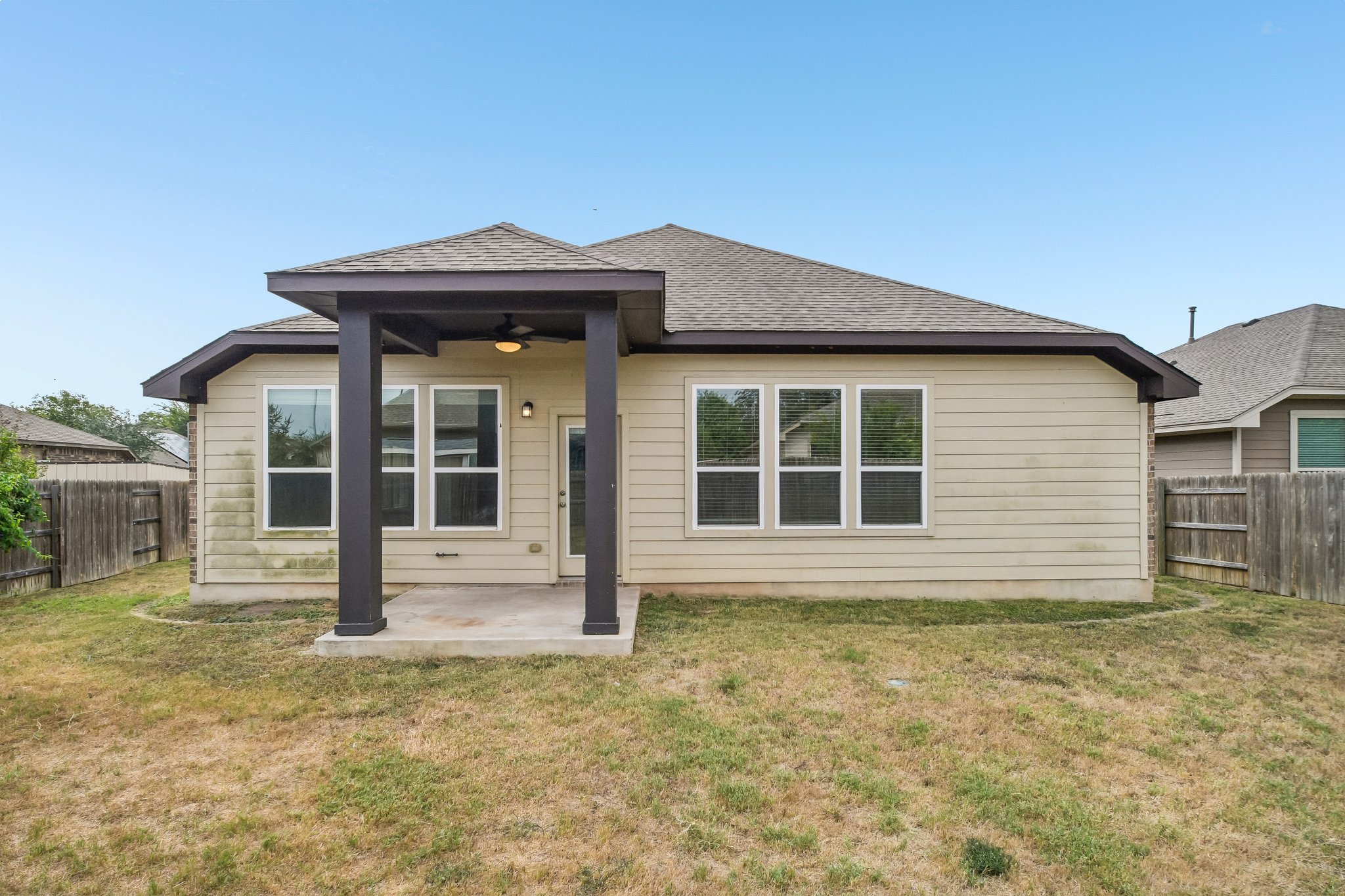 280 Rimrock Court Bastrop, TX 78602 - Photo 29 of 34 A covered back porch overlooks the grassy yard of this single-story home.