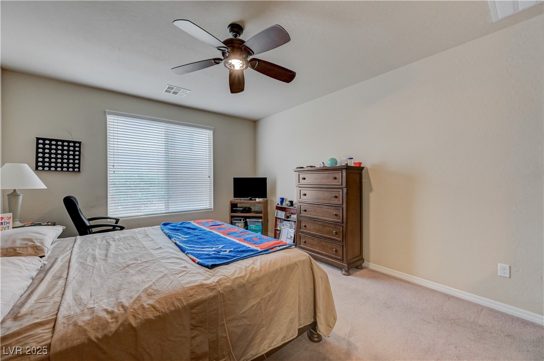 6970 Motley Road Las Vegas, NV 89178 - Photo 28 of 52 Master Bedroom featuring carpet, ceiling fan, and connected Master Bathroom