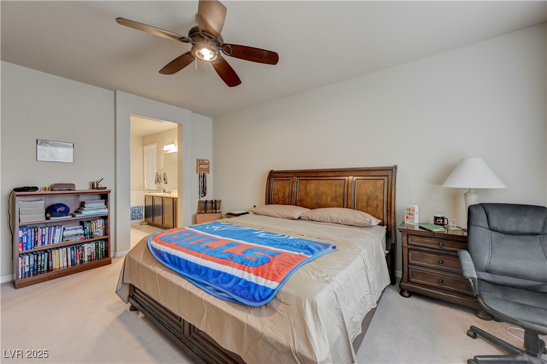 6970 Motley Road Las Vegas, NV 89178 - Photo 29 of 52 Master Bedroom featuring carpet, ceiling fan, and connected Master Bathroom