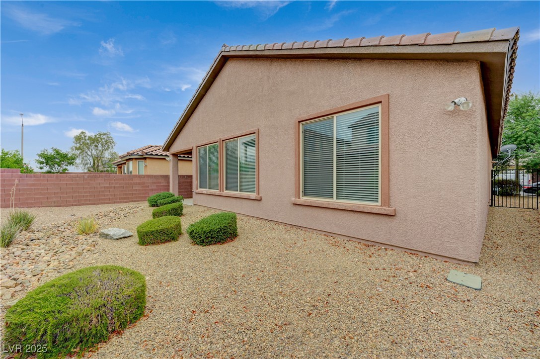 6970 Motley Road Las Vegas, NV 89178 - Photo 49 of 52 Backyard with low-maintenance landscaping and covered patio