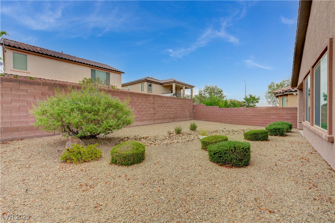 6970 Motley Road Las Vegas, NV 89178 - Photo 50 of 52 Backyard with low-maintenance landscaping and covered patio
