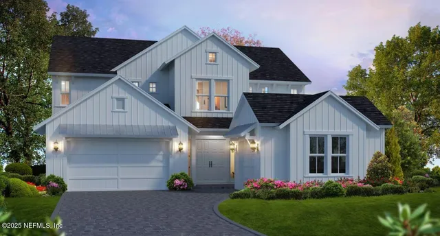 a front view of a house with a garden and plants