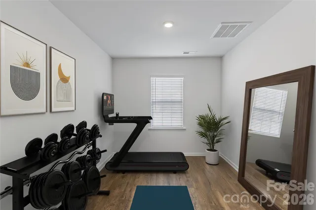 a room with gym equipment and a window