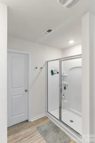 a bathroom with a glass shower door