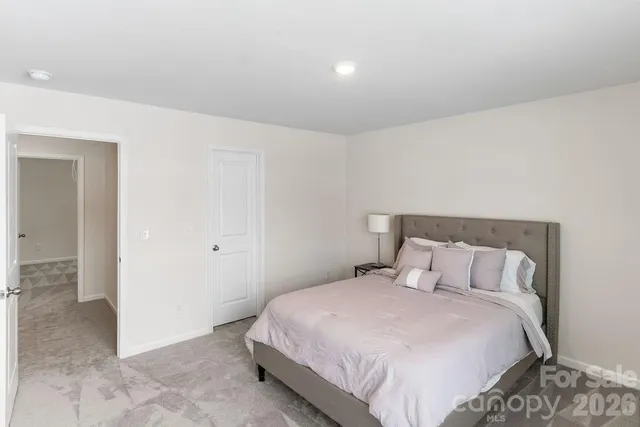 a bedroom with a bed and a painting