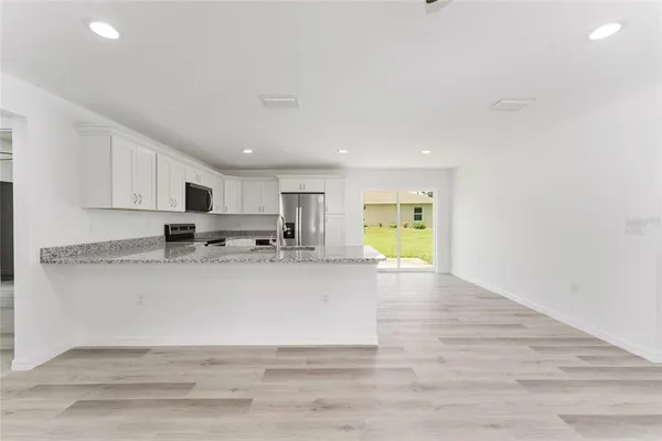 a view of kitchen with wooden floor and window