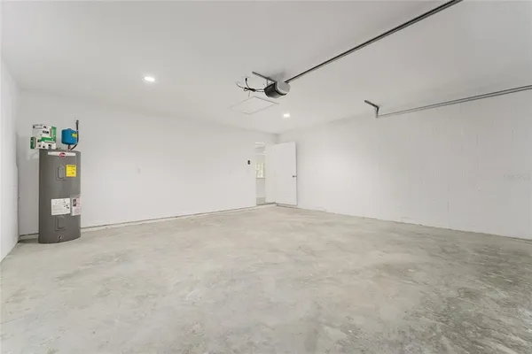 an empty room with window and ceiling fan