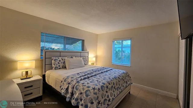 a bedroom with a bed and painting on the wall