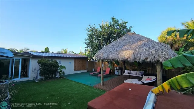 a view of a patio with furniture and a yard