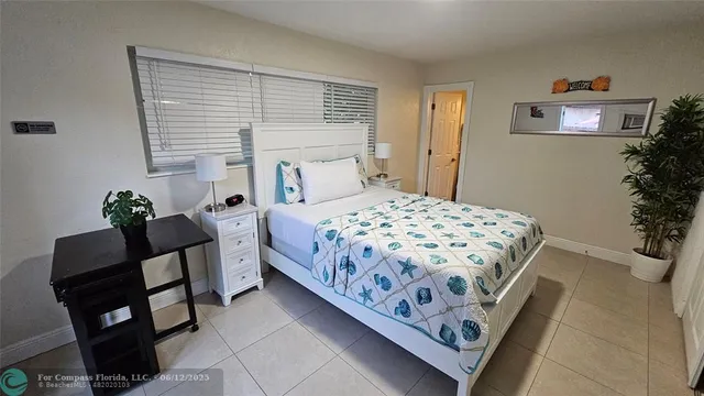 a bedroom with a bed and a potted plant