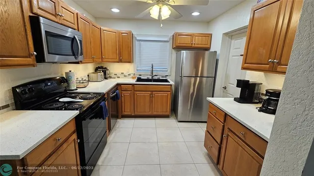 a kitchen with stainless steel appliances a stove microwave and refrigerator
