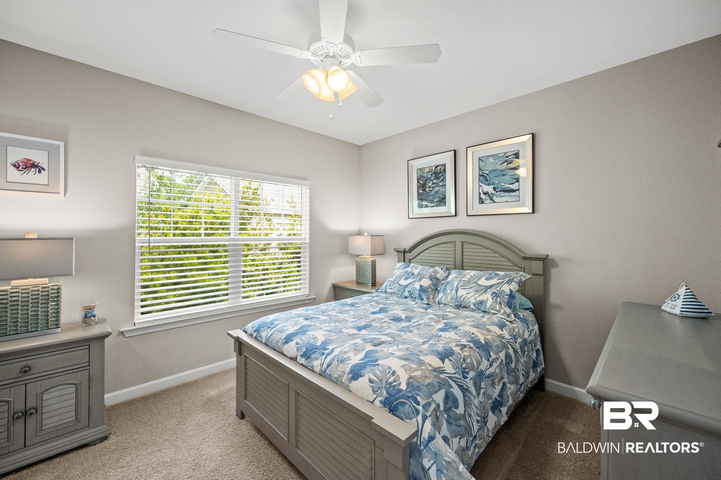 430 West Fort Morgan Road, Unit 1902 Gulf Shores, AL 36542 - Photo 28 of 59 Bedroom featuring ceiling fan and light colored carpet