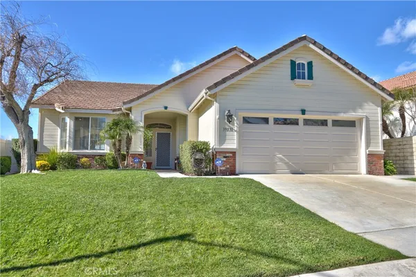 a front view of a house with a yard and garage