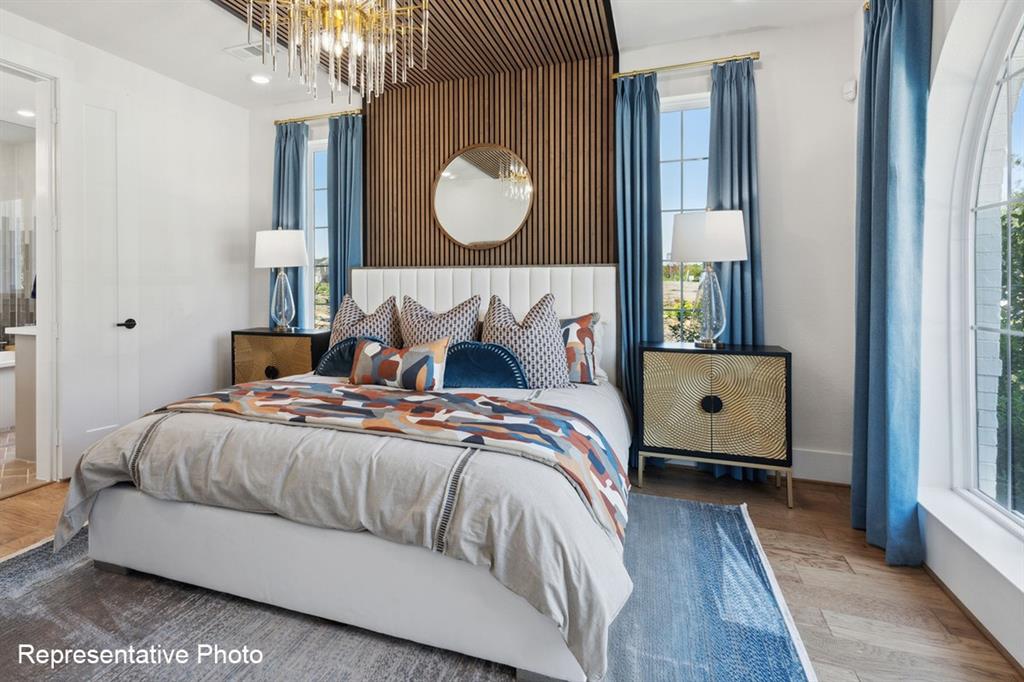 12711 Pne Rdg Trail Wylie, TX 75098 - Photo 13 of 30 a bedroom with a bed and a window with wooden floor