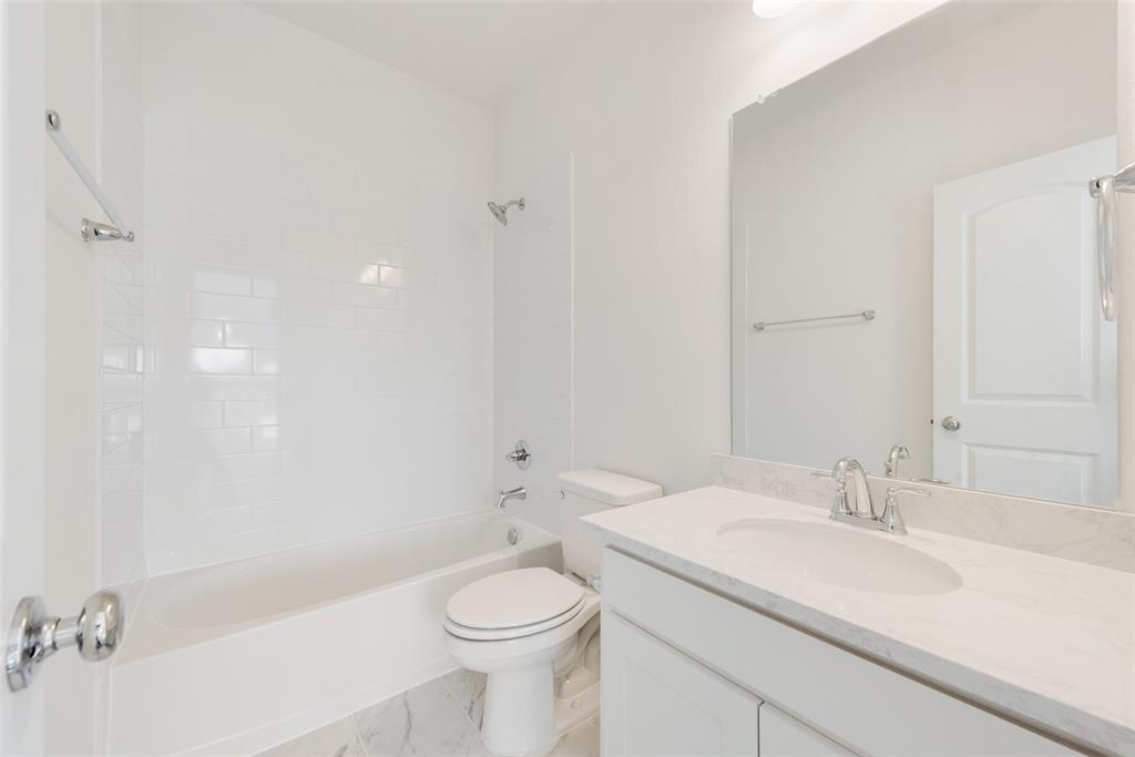 12711 Pne Rdg Trail Wylie, TX 75098 - Photo 23 of 30 a bathroom with a sink a toilet and shower