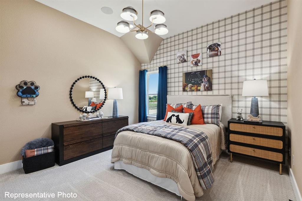 12711 Pne Rdg Trail Wylie, TX 75098 - Photo 25 of 30 a bedroom with a bed and a chandelier