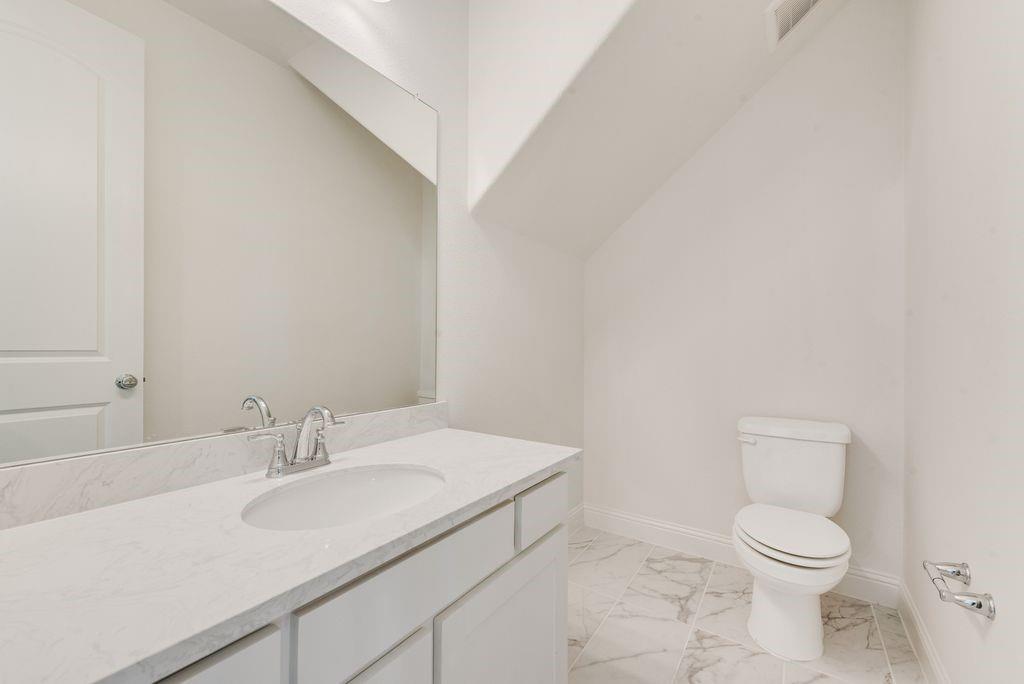 12711 Pne Rdg Trail Wylie, TX 75098 - Photo 26 of 30 a bathroom with a sink a toilet and a mirror