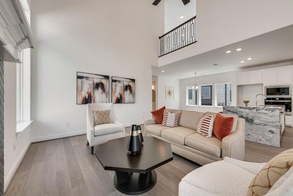 12711 Pne Rdg Trail Wylie, TX 75098 - Photo 6 of 30 a living room with furniture and a wooden floor