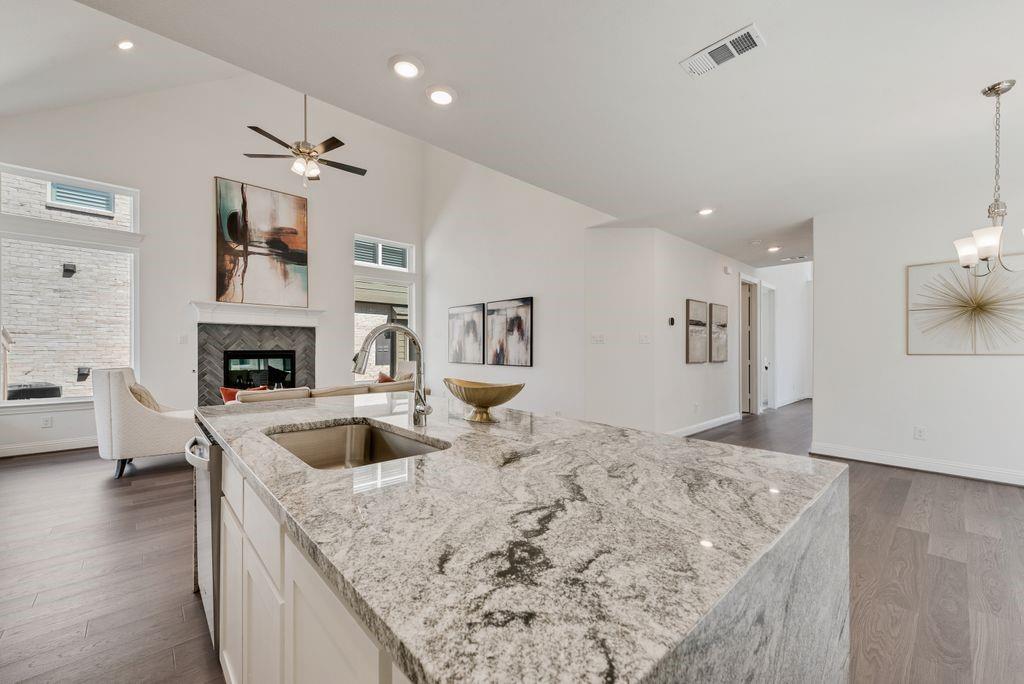 12711 Pne Rdg Trail Wylie, TX 75098 - Photo 8 of 30 a view of living room with granite countertop furniture and fireplace