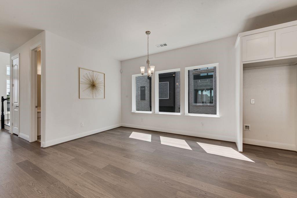 12711 Pne Rdg Trail Wylie, TX 75098 - Photo 10 of 30 a view of an empty room with wooden floor and a window