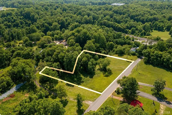 an aerial view of a swimming pool with a yard