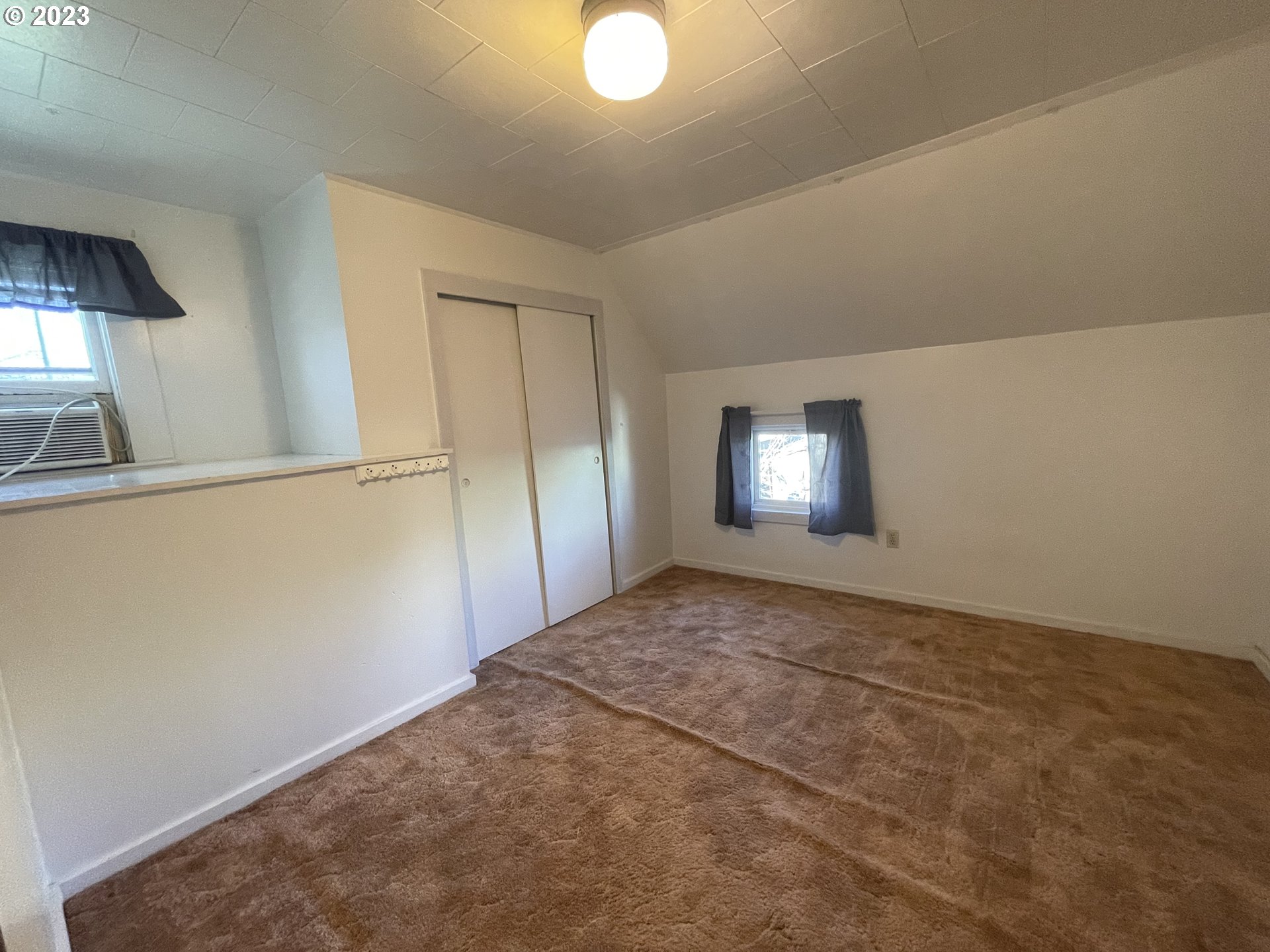 333 Southwest 3rd Street Pendleton, OR 97801 - Photo 17 of 20 an empty room with wooden floor and windows