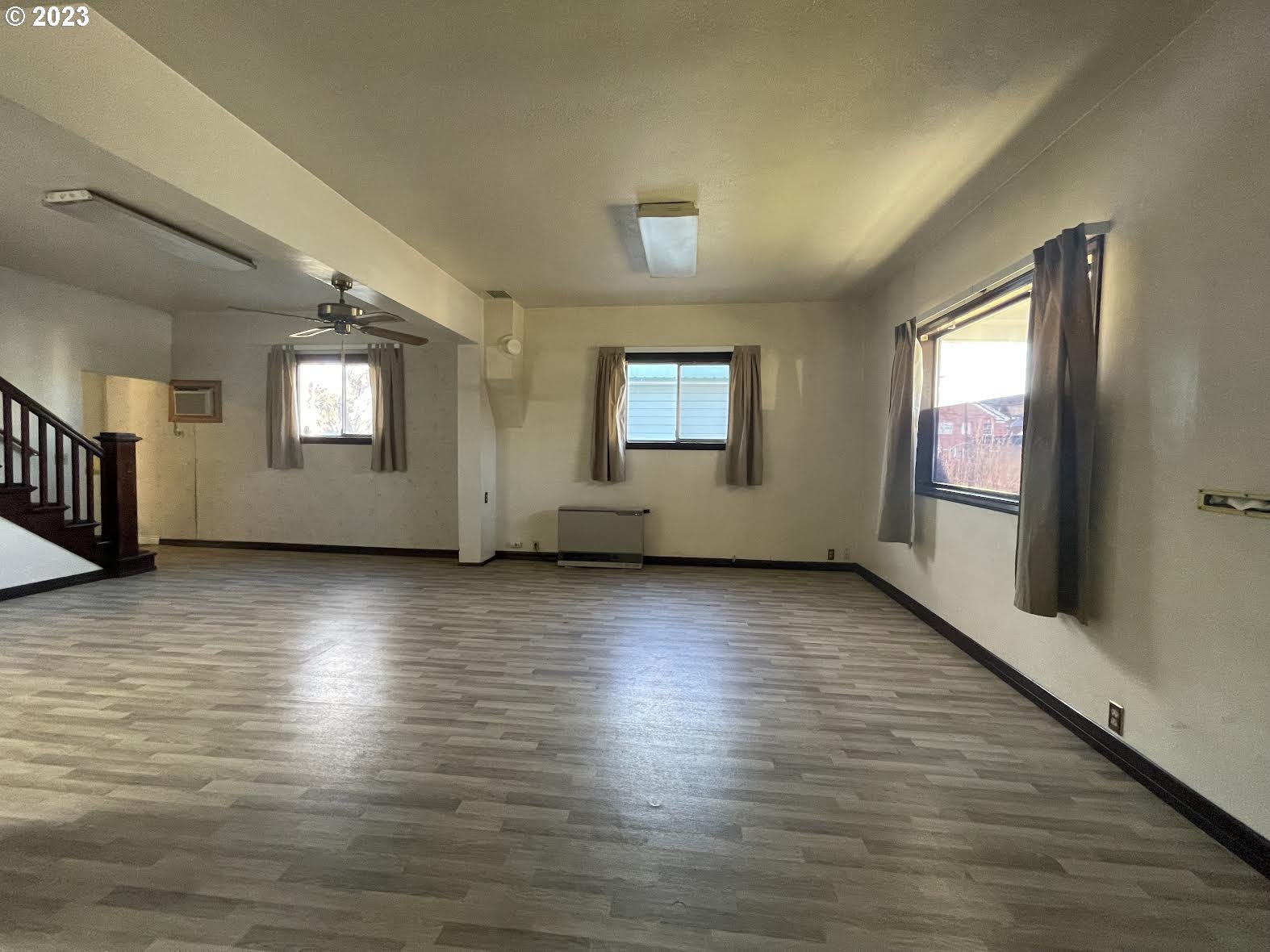 333 Southwest 3rd Street Pendleton, OR 97801 - Photo 6 of 20 an empty room with wooden floor and windows
