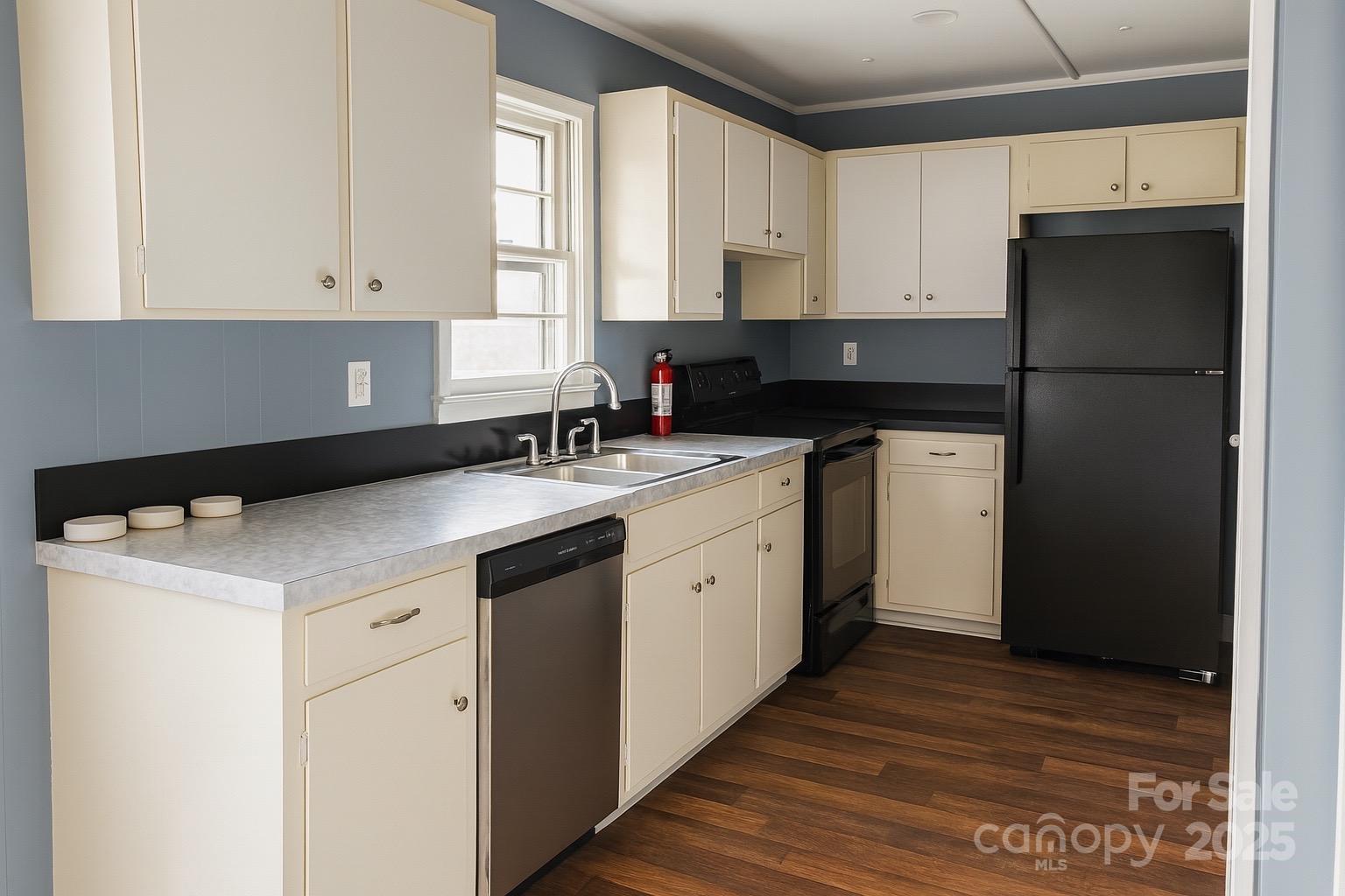 152 Northview-Dorsey Street Rutherfordton, NC 28139 - Photo 2 of 7 a kitchen with a sink dishwasher a refrigerator a stove and white cabinets with wooden floor