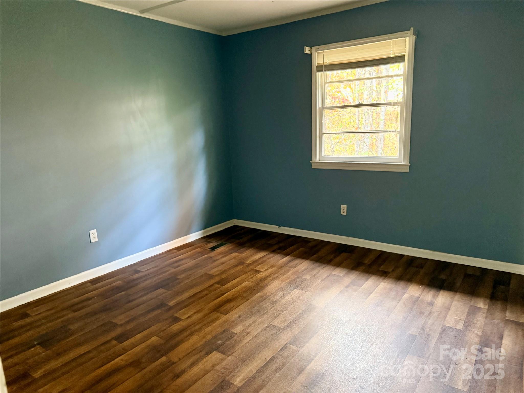 152 Northview-Dorsey Street Rutherfordton, NC 28139 - Photo 5 of 7 a view of an empty room with wooden floor and a window
