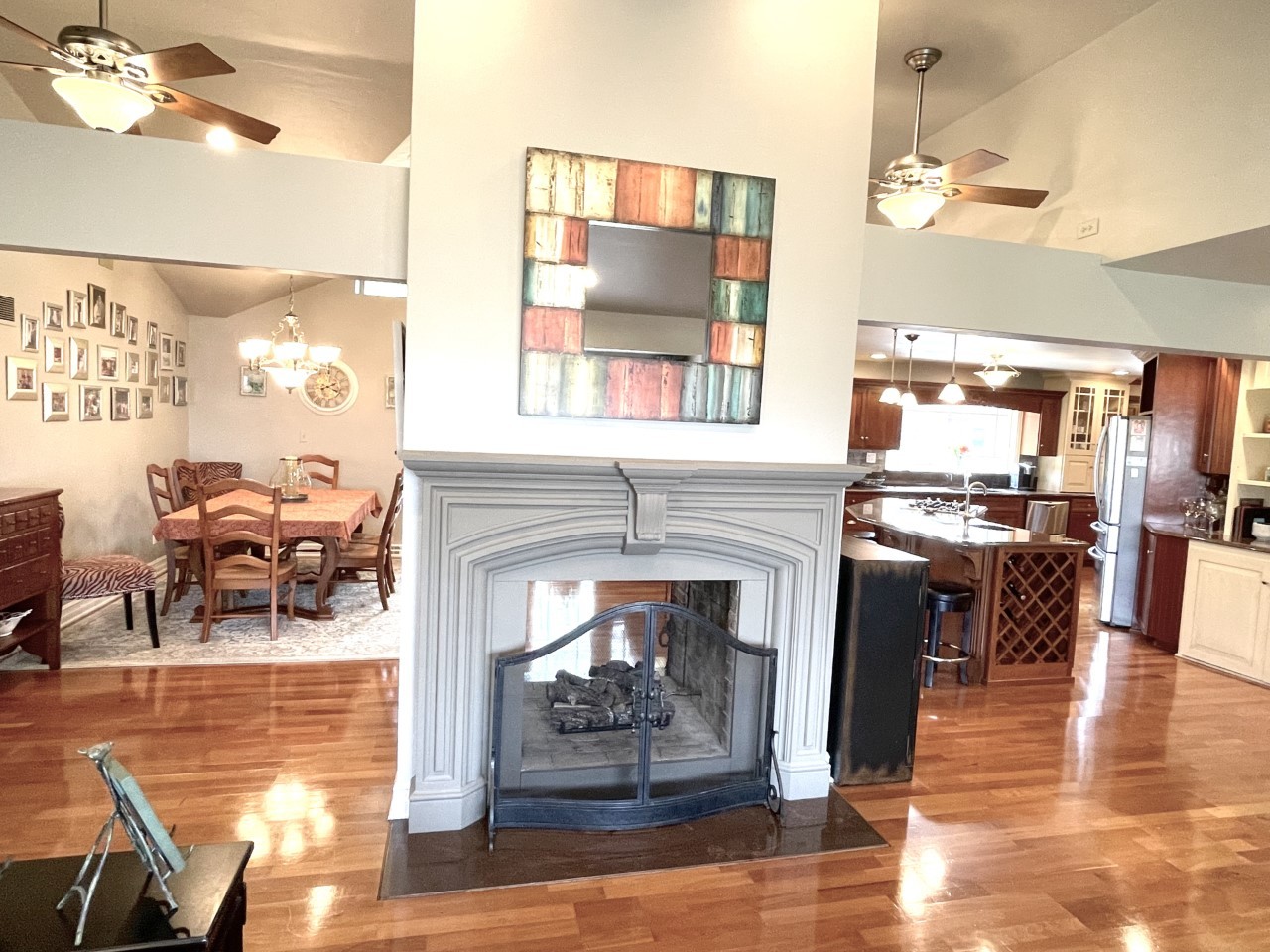 2583 East 259th Road Peru, IL 61354 - Photo 9 of 48 a living room with furniture a fireplace and dining table with wooden floor