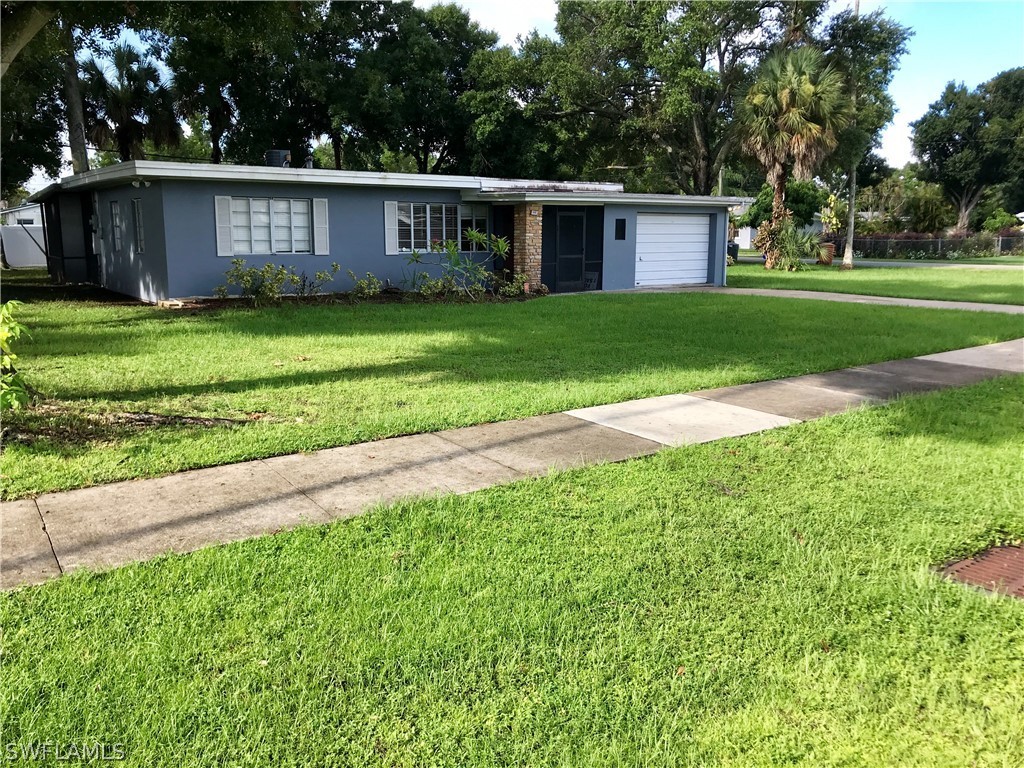1606 Grove Avenue Fort Myers, FL 33901 - Photo 2 of 7 a view of a house with a yard and a large tree