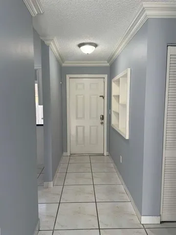 a view of a hallway to rooms