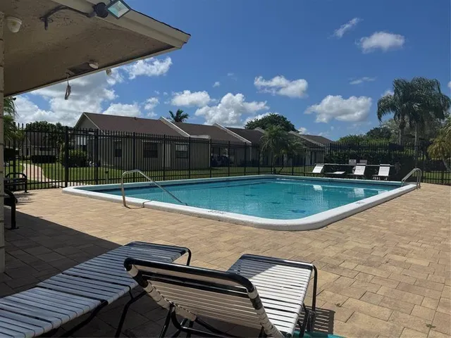 a view of a swimming pool with a patio
