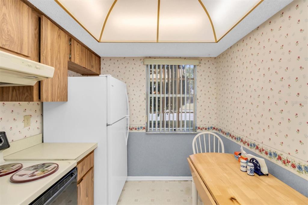 11204 Pembridge Court, Unit 4 Port Richey, FL 34668 - Photo 11 of 58 a bedroom with furniture and a window