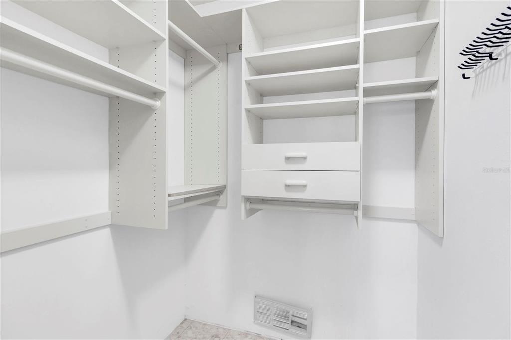 11204 Pembridge Court, Unit 4 Port Richey, FL 34668 - Photo 17 of 58 a view of walk in closet with empty racks