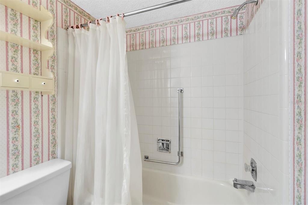 11204 Pembridge Court, Unit 4 Port Richey, FL 34668 - Photo 21 of 58 a bathroom with a shower and a tub