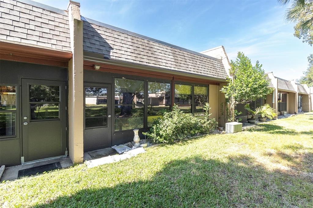 11204 Pembridge Court, Unit 4 Port Richey, FL 34668 - Photo 26 of 58 a view of backyard with potted plants and a table
