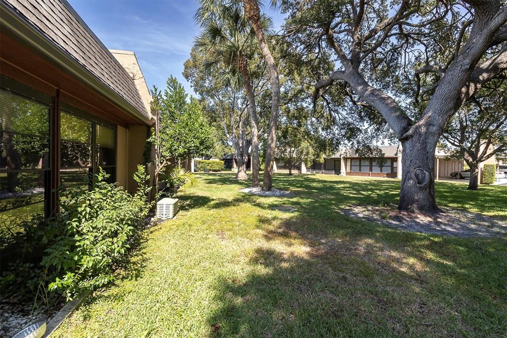 11204 Pembridge Court, Unit 4 Port Richey, FL 34668 - Photo 27 of 58 a front view of a house with a yard