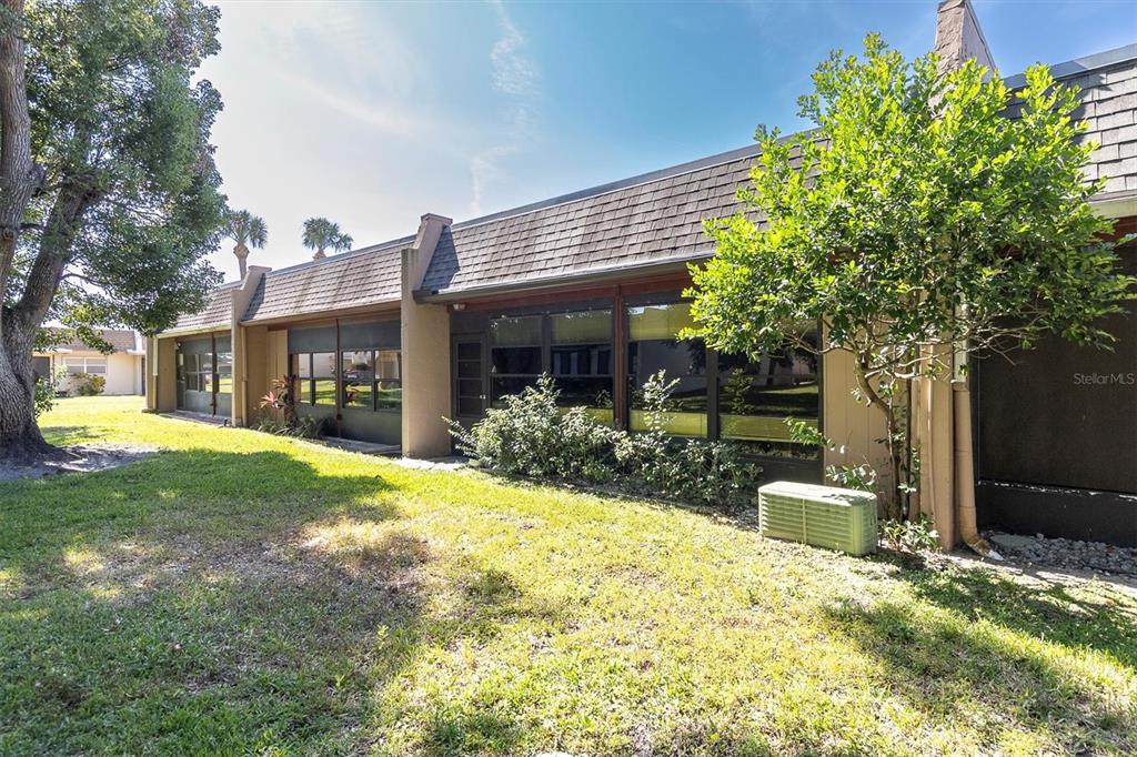 11204 Pembridge Court, Unit 4 Port Richey, FL 34668 - Photo 29 of 58 a view of a house with backyard and sitting area