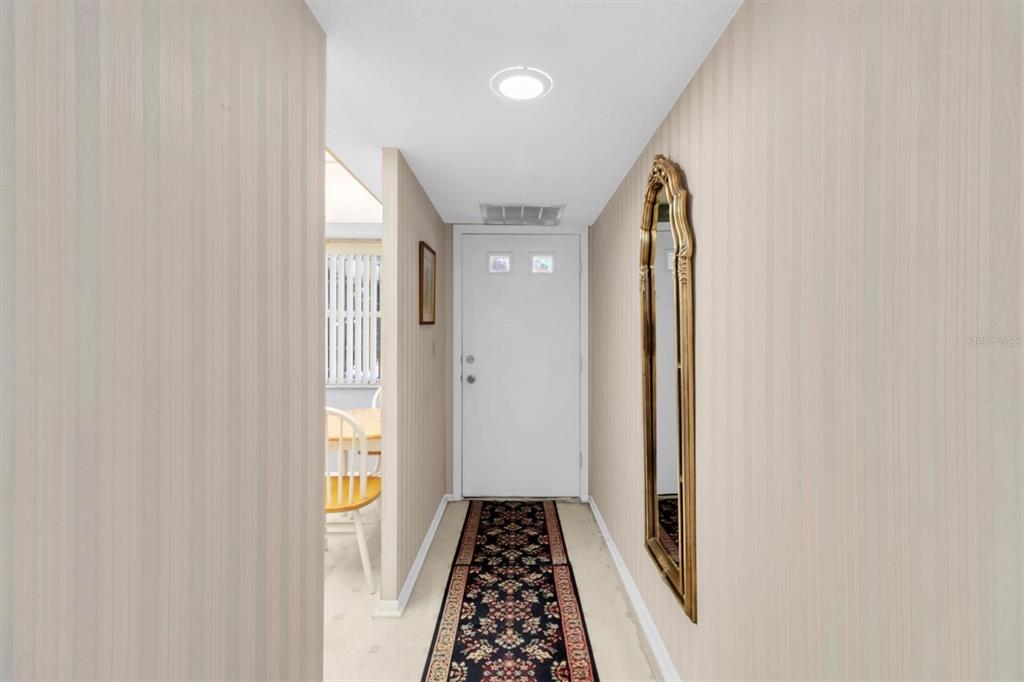 11204 Pembridge Court, Unit 4 Port Richey, FL 34668 - Photo 3 of 58 a view of hallway with wooden floor