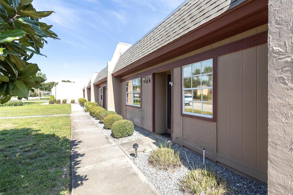 11204 Pembridge Court, Unit 4 Port Richey, FL 34668 - Photo 31 of 58 a front view of a house with a yard